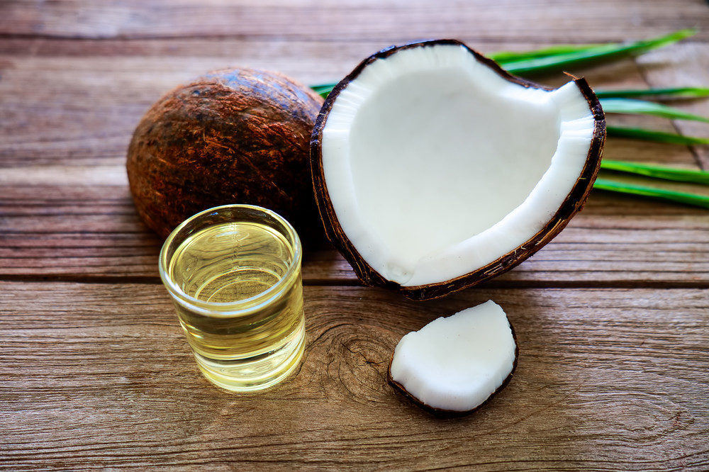 Coconut and oil on table