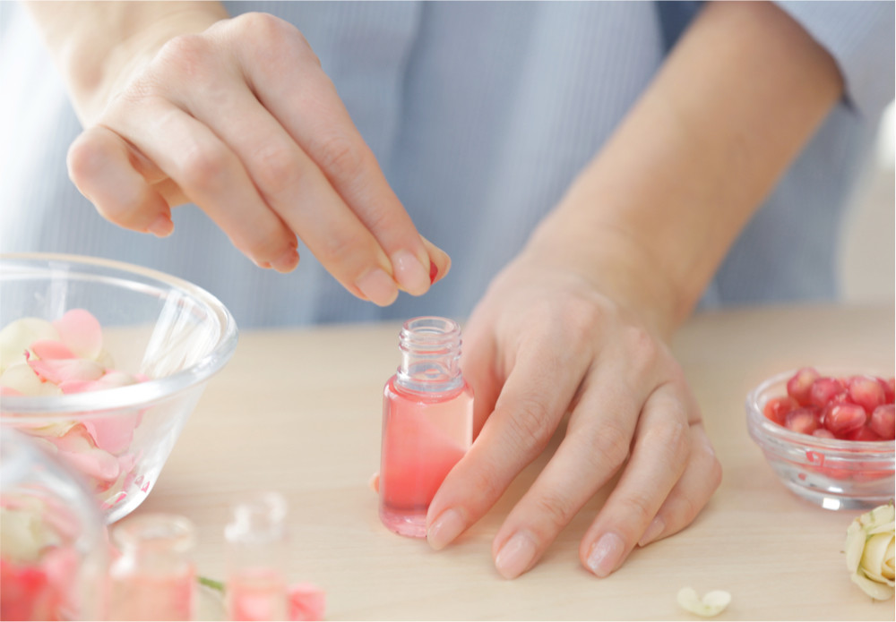 Woman making rose water perfume